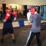 two amateur boxing students sparring
